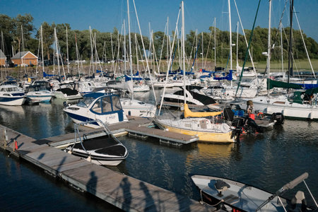 Boats and yachts moored to a pier on a lake. Berthier-sur-Mer, Quebec.