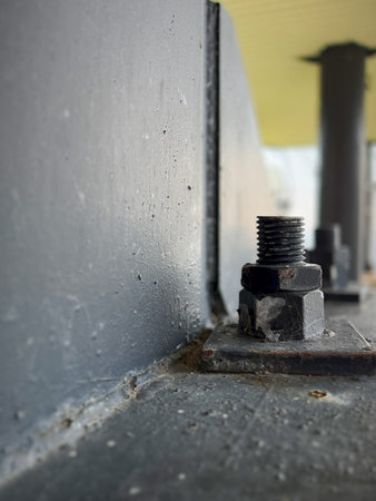Bolt and nut on the wall of an industrial building outdoors
