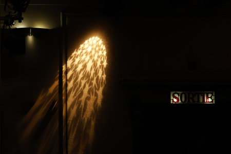 Star-shaped light on the wall of a theater and the sign for the exit.の写真素材