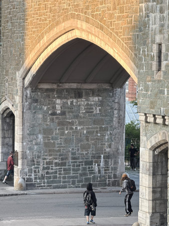 People walk along St-Jean Street in Old Quebec City. St. John's Gate in Quebec city.