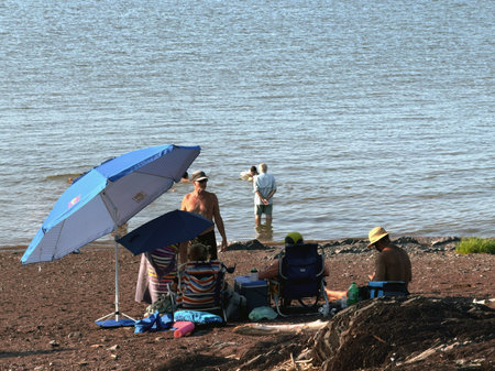 Unidentified tourists relaxing on the beach in Quebec, Canadaのeditorial素材