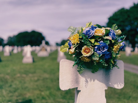 Flowers on a cross in a cemetery in Quebec.