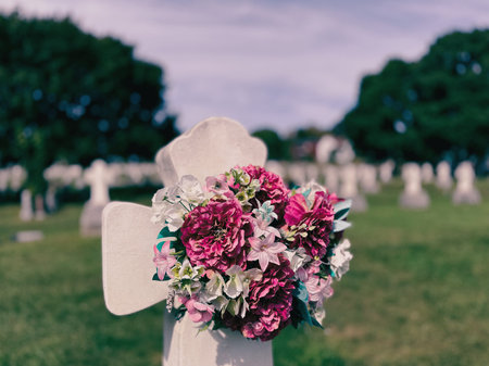 Flowers on a cross in a cemetery in Quebec.
