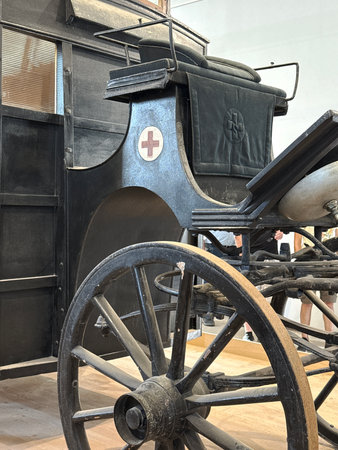 An old vehicle with a wooden wheel and a cross in a museum. Detail of an old vehicle.の写真素材