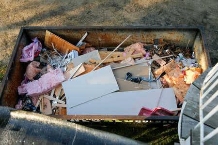 Dumping into a container. Waste container on a construction site.