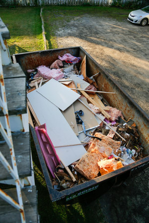 Dumping into a container. Waste container on a construction site.