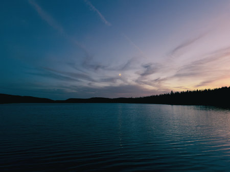 Beautiful sunset over the lake in the forest. A lake at sunset in the forest. Quebec, Canada.の写真素材