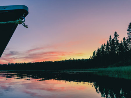 Fishing boat on the lake at sunset. A lake at sunset in the forest. Quebec, Canada.の写真素材