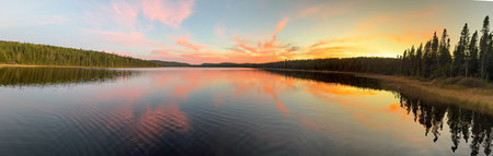 Panoramic view of the lake at sunset. Beautiful summer scenery. Beautiful sunset over the lake in...