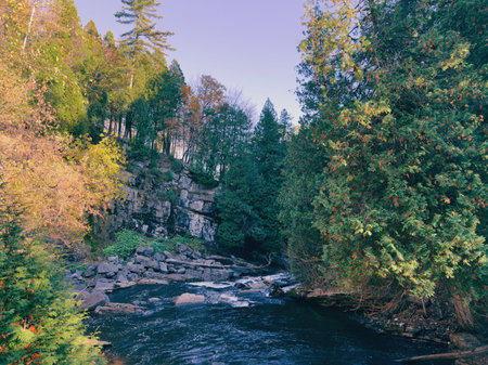 Autumn landscape with a waterfall in the forest.
