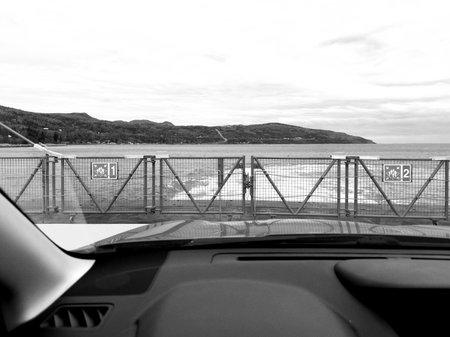 View from the car on the sea. Black and white photo. View from the car on the ferry and the sea in Charlevoix, Quebec, Canada.の写真素材