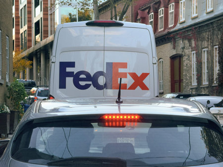 A FedEx delivery truck in traffic.