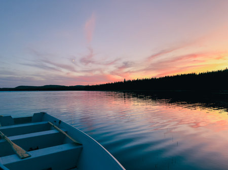 Boat on the lake at sunset. A lake at sunset in the forest.の写真素材
