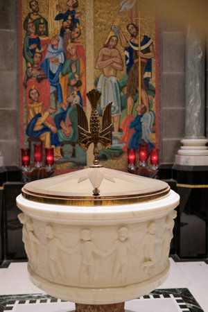 Quebec, Canada - 10-31-2025: The baptismal font in interior of the Basilica of...