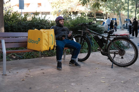 Glovo food delivery by bicycle in the streets of Barcelona,  Spainのeditorial素材