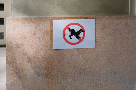 Sign indicating that it is forbidden for dogs to urinate on a wall in a public place.の写真素材