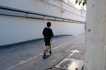A child rides a scooter. Urban living concept.の写真素材