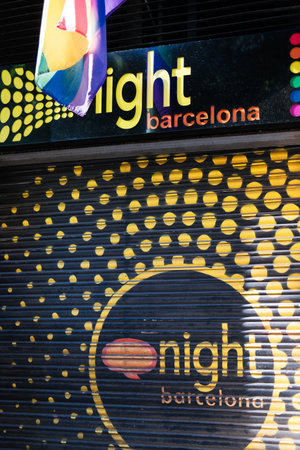 Barcelona, ââââSpain. The Night Barcelona, ââa dating club located in the Eixample district. LGBTQ+ bar. The flag of the LGBT community on the facade of a building.のeditorial素材
