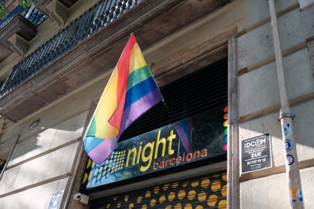 Barcelona, ââââSpain. The Night Barcelona, ââa dating club located in the Eixample district. LGBTQ+ bar. The flag of the LGBT community on the facade of a building.のeditorial素材