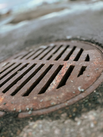 rusty manhole cover on the street, closeup of photoの写真素材