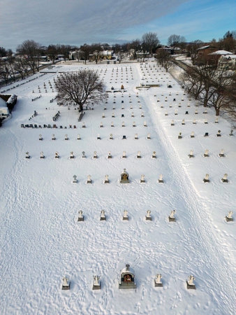 Aerial view of a cemetery on a snowy hill in winter. Aerial view of a snow-covered cemetery in...