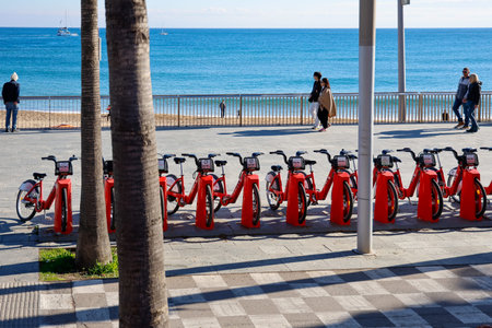 Red rental bikes for rent on the promenade in Barcelona, Spainのeditorial素材