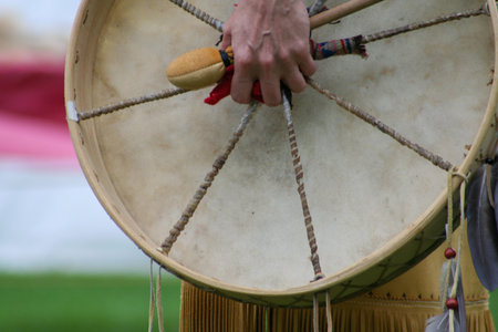 Native American woman in traditional dress with a traditional drum during the annual powwow, Quebec,...