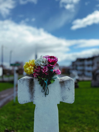 Flowers on a grave in a cemetery in Quebec.