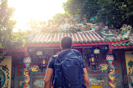men backpacker looking at a temple in Bangkok , Thailand , Southeast asia .の写真素材