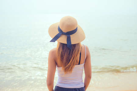 rear view of an attractive women looking at clear water sea in day . Thailand , Asiaの写真素材