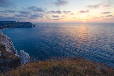 beautiful sunset at Etretat natural arch , a commune in the Seine-Maritime department in the Normandy region of north western Franceの写真素材