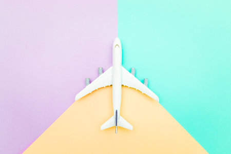 miniature plane on pastel colors background , travel and vacation concept