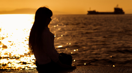 Girl on sunset seaの写真素材