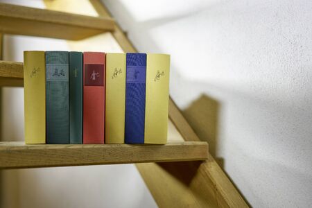 Colorful books on a stairway in a country houseの写真素材