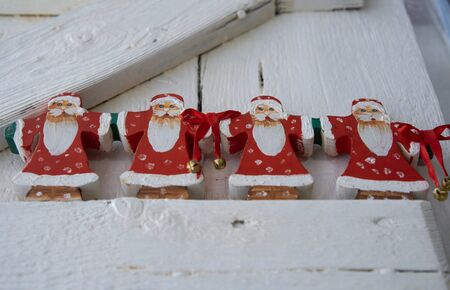 Group of father christmas on a white shabby wooden element, low angleの写真素材