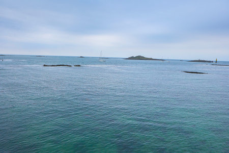 Sea at Roscoff, Brittany, cloudy sky, small boats in the water