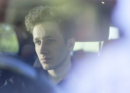 Young attractive driver with hands on wheel.の写真素材