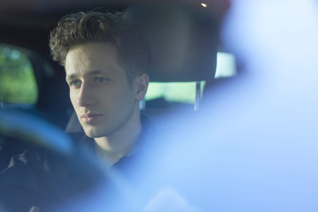 Young attractive driver with hands on wheel.の写真素材