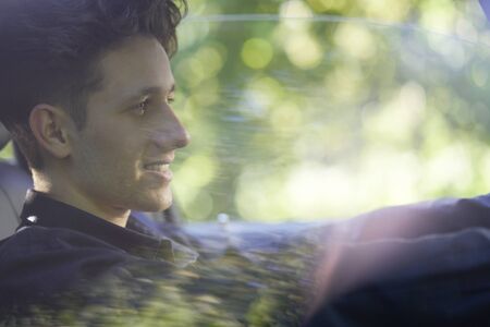 Young smiling driver having fun while taking driving lessonsの写真素材