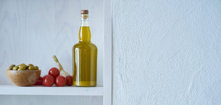 panoramic picture from a bottle of healthy organic olive oil on shelf on the wall in mediterranean style with copy space in greeceの写真素材