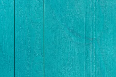 Colourful postcard of bluegreen textured wooden boards with a transparent artful tulipの写真素材