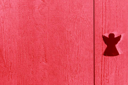 Red wooden textured boards with an angel, background and copy spaceの写真素材