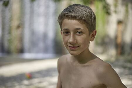 Portrait of a handsome self-confident young teenager in summer relaxed happy moodの写真素材