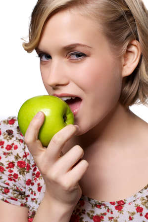 Young woman biting in an appleの写真素材