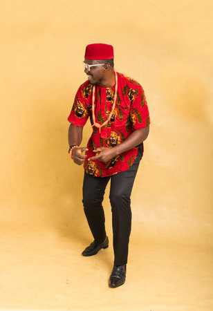 Igbo Traditionally Dressed Business Man Happy at a Side Productの写真素材