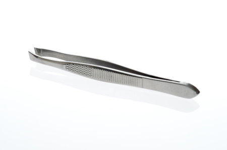 Close-up of tweezers on a white backgroundの写真素材