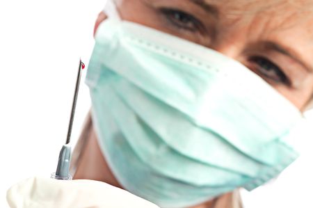 syringe needle with a drop of bloodの写真素材