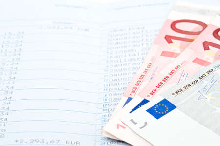 Close-up of savings in money and bank statementの写真素材