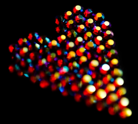 Colorful strass heart pattern on black backgroundの写真素材