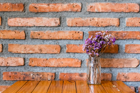 Purple dry flowers in vases on wooden boardsの写真素材